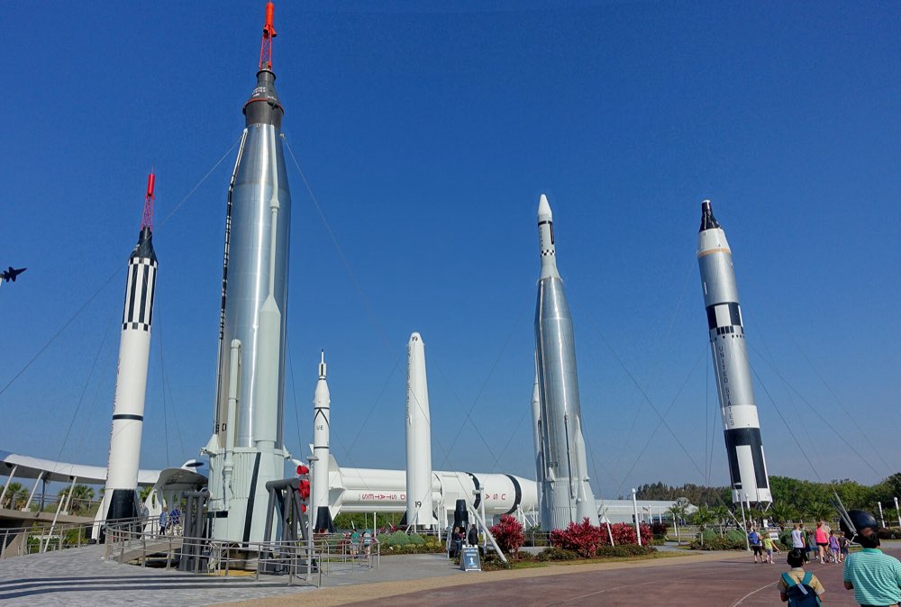 White and silver rockets standing upright under a deep blue sky in the Rocket Garden at the Kennedy Space Center Visitor Complex