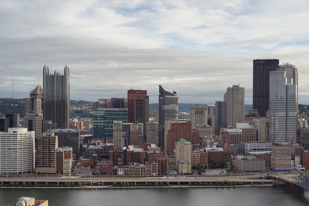 Downtown Pittsburgh's towers rising above the Monongahela River, seen from Mount Washington on a cloudy day