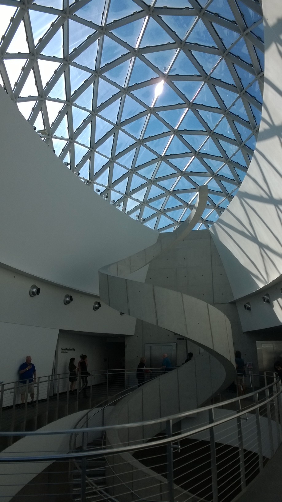The glass geodesic dome and spiral staircase in the Dalí Museum atrium
